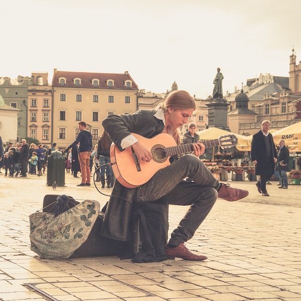 guitar player playing on street