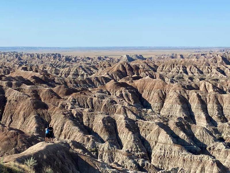 Photo of the a son and dad standing looking into the badlands in south dakota